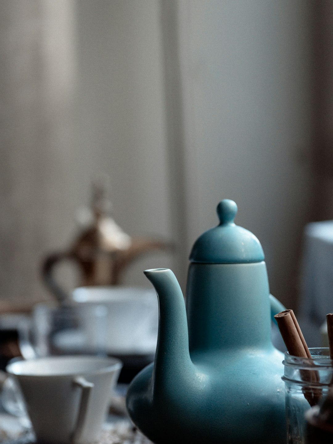 a-blue-teapot-sitting-on-top-of-a-table-y4pt6qug6e4